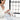 Kindred & Kin woman in a white robe pouring Bathorium Eucalyptus Apothecary bath soak into a bathtub for muscle recovery