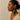 Kindred & Kin Sutura Feather Drop Earrings: black bone feather with brass wirework, coral bead, and spiral detail.