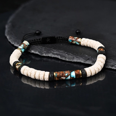 Kindred & Kin Vanguard lava bead bracelet featuring beige and black beads with bronze and blue emperor stone accents.