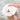 Bathorium Mama’s Perch bath bomb dissolving in water with rose petals, coconut milk, and frothy bubbles.