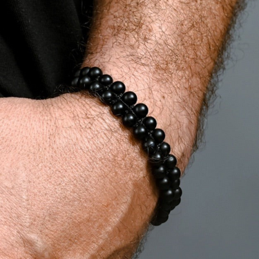 Starfish Project matte black agate beaded rope bracelet worn on a man's wrist, featuring a double-strand design.