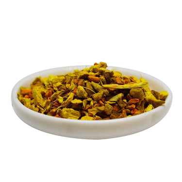 Kindred & Kin Brooklyn Tea ginger turmeric tea blend with dried root pieces and orange peel in a small white dish