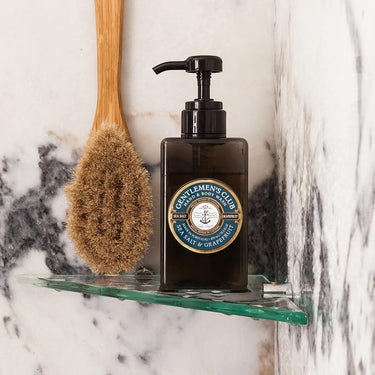Castelbel Kindred & Kin Gentlemen's Club Sea Salt & Grapefruit Hand & Body Wash bottle with pump dispenser in shower.