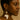 Kindred & Kin white Africa silhouette earrings with cowrie shell detail and aged brass accents.