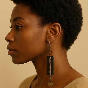 Kindred & Kin Kora Drop Earrings: carved horn pendant with aged brass accents and disk. Handcrafted in Senegal.