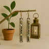 Kindred & Kin Nomad Lineage bone and brass wire wrapped linear earrings with natural patterns.