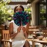 Kindred & Kin vibrant folding fan with black fabric, teal and magenta African print, and wrapped handles.