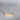 Kindred & Kin gold plated bar necklace with engraved Act Justly message on an adjustable chain against a grey surface