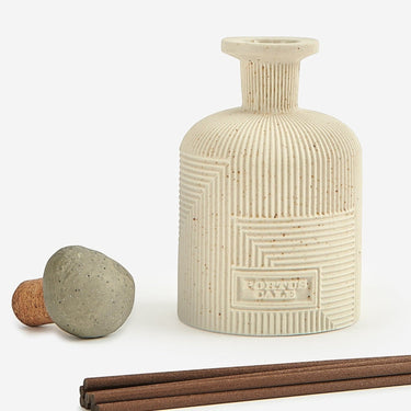 Kindred & Kin Hajjar Blanc ceramic diffuser with textured stone-like finish and geometric pattern. Includes cork stopper and reeds.
