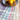 Kindred & Kin handwoven cotton kitchen towels in assorted striped colors with a decorative bowl of lemons
