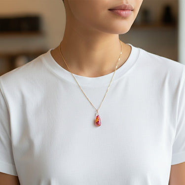Kindred & Kin teardrop pendant with real rose petals and gold leaf in clear Eco-Resin on an 18" gold-plated bronze chain.